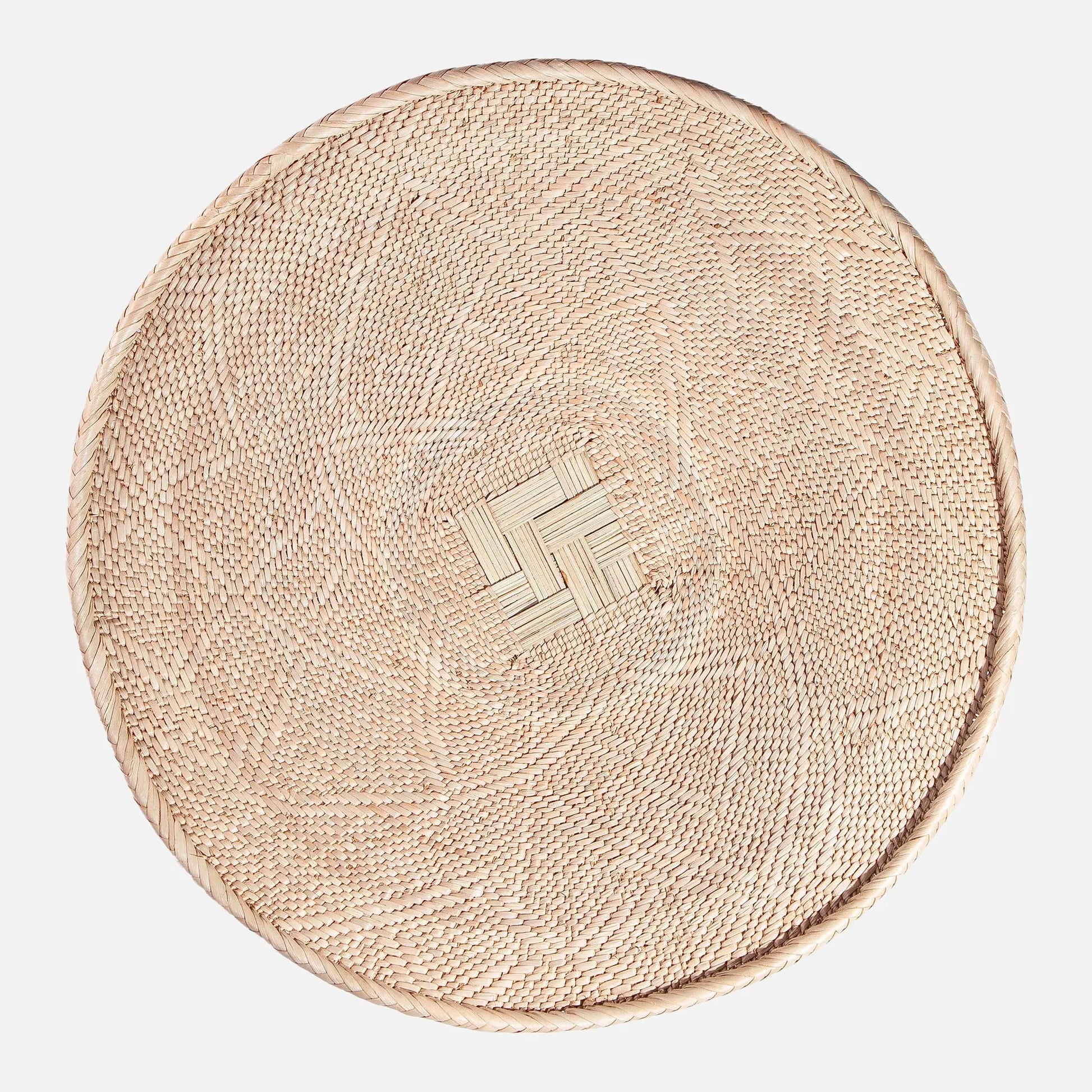 Round Binga wall basket handwoven in Zimbabwe, neutral natural fiber with geometric weave